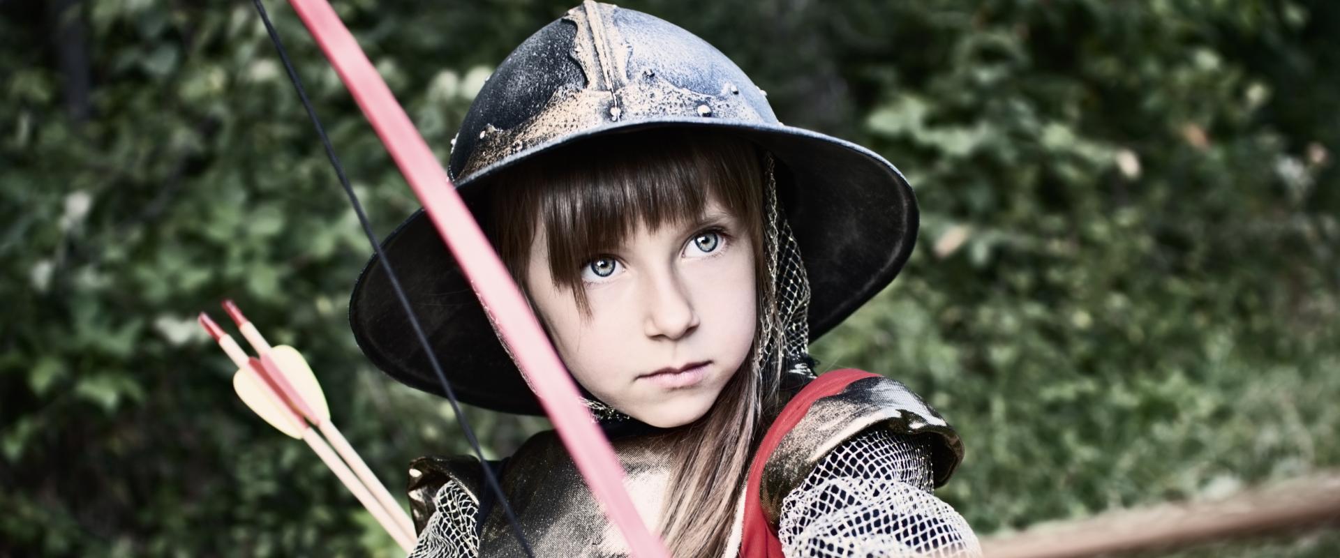 young girl in medieval armour with bow and arrow