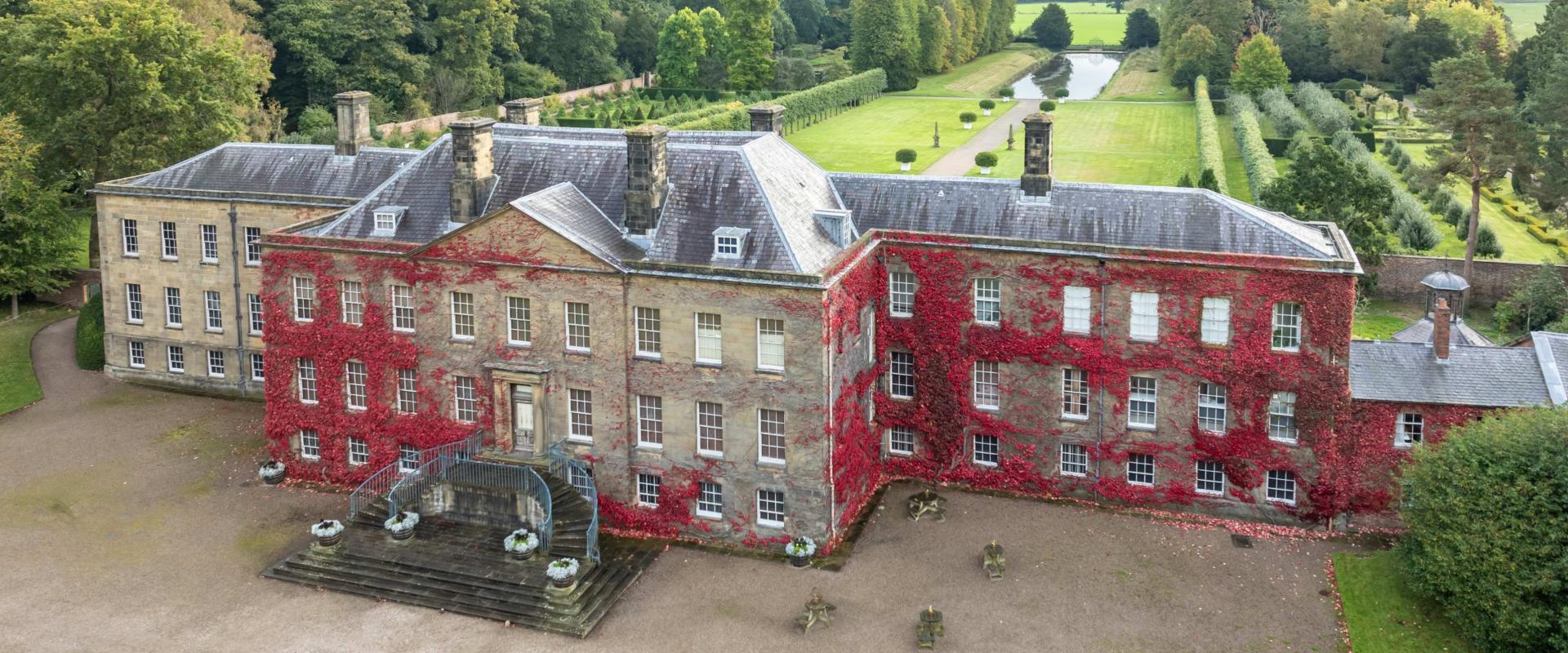 image of the outside of Erddig Hall and Garden covered in red leaves