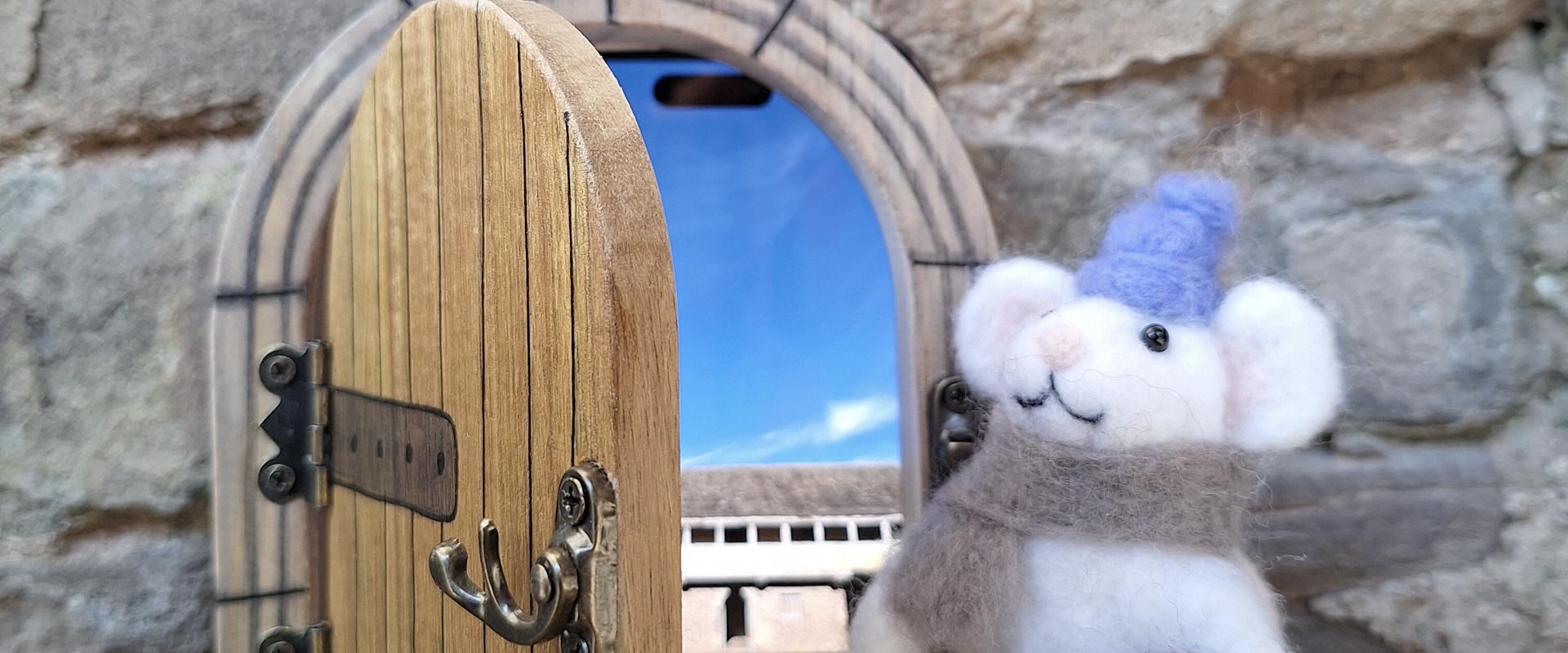 mouse waiting by door ready for an adventure