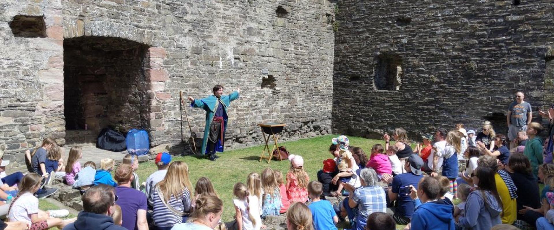 image of magician preforming to a crowd