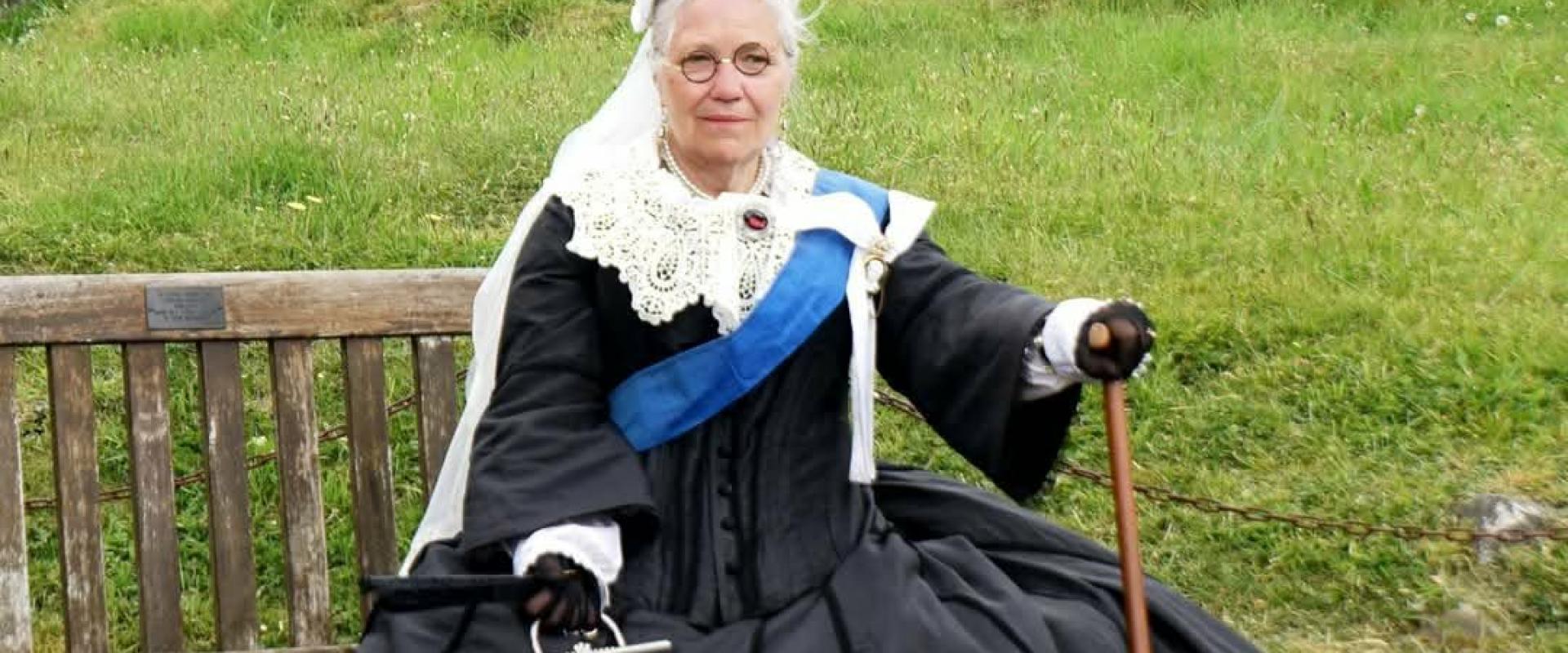 Queen Victoria sitting on a bench