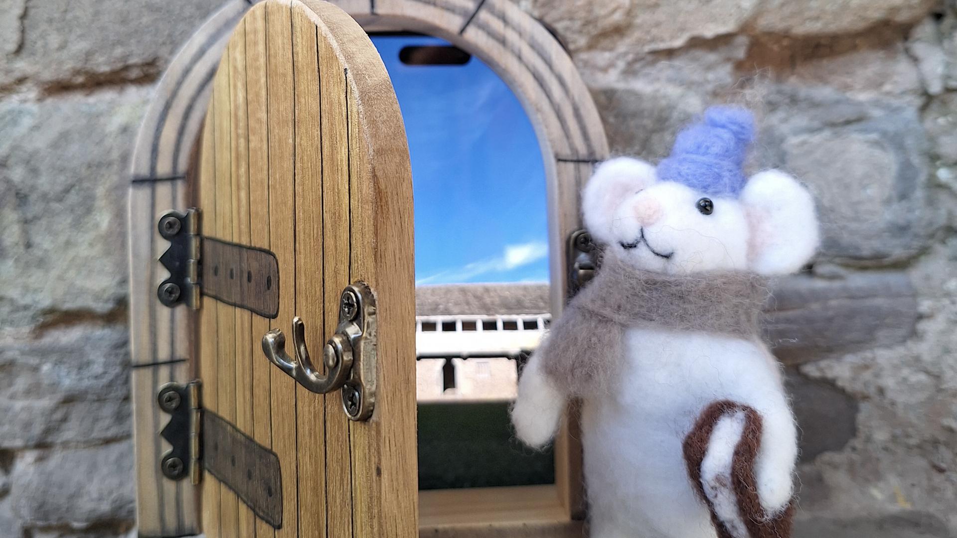 mouse waiting by door ready for an adventure